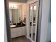 Bathroom with a vanity, mirror, and soft lighting, offering a relaxing atmosphere at 901 Guys Sw Ct, Lilburn, GA 30047