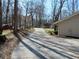 Long driveway leading to the home, surrounded by mature trees and lush landscaping at 901 Guys Sw Ct, Lilburn, GA 30047