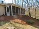 Exterior view of home and screened in porch with trees visible in background at 901 Guys Sw Ct, Lilburn, GA 30047