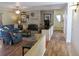 Cozy living room with a brick fireplace, ceiling fan, and comfortable seating area with hardwood flooring at 901 Guys Sw Ct, Lilburn, GA 30047