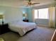 Relaxing main bedroom featuring a ceiling fan, natural light, and neutral carpeting at 901 Guys Sw Ct, Lilburn, GA 30047