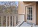 Balcony with white railing and a view of the surrounding trees at 115 Ashford Cir, Dunwoody, GA 30338