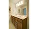 Bright bathroom featuring a double sink vanity with wood cabinets and a large mirror at 39 Clubhouse Way, Acworth, GA 30101