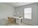 Bright bedroom with a desk, wicker chair, and window at 39 Clubhouse Way, Acworth, GA 30101