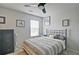 Cozy bedroom featuring a ceiling fan, window, and neatly arranged bed and furnishings at 39 Clubhouse Way, Acworth, GA 30101