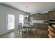 A dining area near kitchen featuring wood floors, a light fixture and plenty of light at 39 Clubhouse Way, Acworth, GA 30101