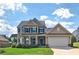 Charming two-story home with well-maintained lawn and attached two-car garage on a sunny day at 39 Clubhouse Way, Acworth, GA 30101