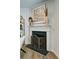 A close up view of a beautifully decorated fireplace with custom screen at 39 Clubhouse Way, Acworth, GA 30101