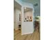 Well-lit hallway with stylish wood floors, white trim, and a decorative nook at 39 Clubhouse Way, Acworth, GA 30101