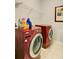 Modern laundry room with red front-load washer and dryer at 39 Clubhouse Way, Acworth, GA 30101