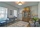 Comfortable living area with a desk, ample natural light, and a display cabinet filled with decor at 39 Clubhouse Way, Acworth, GA 30101