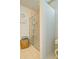 Bright bathroom featuring a shower, neutral tile, and woven basket for storing towels at 39 Clubhouse Way, Acworth, GA 30101