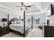 Serene main bedroom with a tray ceiling and lots of natural light at 5041 Stone Moss Way, Hoschton, GA 30548