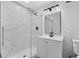 Bathroom with frameless glass shower, tile surround, and modern vanity at 8744 Bellwood Ct, Riverdale, GA 30274