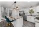 Modern kitchen featuring stainless steel appliances, granite countertops, a kitchen island with barstools, and hardwood floors at 8744 Bellwood Ct, Riverdale, GA 30274