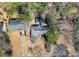 Aerial view of a home with a spacious yard surrounded by lush trees and neighboring properties at 1446 Lively Ridge Ne Rd, Atlanta, GA 30329
