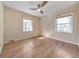 Bright bedroom with hardwood floors, two windows, and ceiling fan at 1446 Lively Ridge Ne Rd, Atlanta, GA 30329