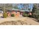 Charming single-story brick home with a well-maintained front yard and mature trees, creating a welcoming curb appeal at 1446 Lively Ridge Ne Rd, Atlanta, GA 30329