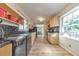 Kitchen featuring wood cabinets, black tile backsplash, stainless steel dishwasher and tile floors at 1446 Lively Ridge Ne Rd, Atlanta, GA 30329