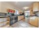 Efficient kitchen with sleek black countertops, modern appliances, wood cabinets and stylish light fixtures at 1446 Lively Ridge Ne Rd, Atlanta, GA 30329