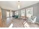 Open living room with hardwood floors, comfortable seating, and bright light from exterior windows and glass patio doors at 1446 Lively Ridge Ne Rd, Atlanta, GA 30329