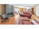 Inviting living room with hardwood floors, brick fireplace, and a comfortable seating area bathed in natural light at 1446 Lively Ridge Ne Rd, Atlanta, GA 30329