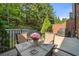 Relax and unwind in the back patio area with comfortable seating, a table with flowers, and a grill at 3633 Broughton Se Cir, Atlanta, GA 30339