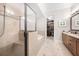 Elegant bathroom with a glass shower, soaking tub, dual vanity, and a walk-in closet at 3633 Broughton Se Cir, Atlanta, GA 30339