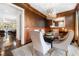 Dining room featuring dark brown walls, wood trim, and a modern light fixture at 3633 Broughton Se Cir, Atlanta, GA 30339