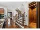 Bright entryway featuring a wooden staircase, elevator, and gleaming hardwood floors at 3633 Broughton Se Cir, Atlanta, GA 30339