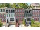 Exterior of a stylish townhome with a red brick facade and balcony at 3633 Broughton Se Cir, Atlanta, GA 30339
