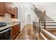Hallway with hardwood floors, staircase, and butler's pantry area with custom cabinets and granite countertop at 3633 Broughton Se Cir, Atlanta, GA 30339