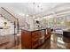Open kitchen featuring dark granite countertops, stairs, stainless steel appliances, and an island at 3633 Broughton Se Cir, Atlanta, GA 30339