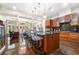 Open-concept kitchen with a central island, stainless steel appliances, and wood cabinetry at 3633 Broughton Se Cir, Atlanta, GA 30339