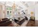 Bright living room with coffered ceilings, modern furniture, and natural light from large windows at 3633 Broughton Se Cir, Atlanta, GA 30339