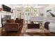 Cozy living room with a fireplace, large windows, and comfortable seating arrangement at 3633 Broughton Se Cir, Atlanta, GA 30339