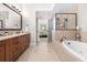 A bright bathroom offers dual sinks, a soaking tub, a walk-in shower, and access to the main bedroom at 3633 Broughton Se Cir, Atlanta, GA 30339