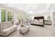 Spacious primary bedroom with large windows, seating area, and elegant chandelier at 3633 Broughton Se Cir, Atlanta, GA 30339
