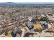 An aerial view of beautiful homes in a wooded area, with mature trees and manicured lawns on a sunny day at 4375 Maverick Nw Ln, Kennesaw, GA 30152