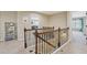 Bright hallway features neutral walls, carpet, decorative wrought iron railing, and access to adjacent rooms at 4375 Maverick Nw Ln, Kennesaw, GA 30152