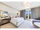 Bright and airy bedroom with a large bed, access to a balcony, and stylish decor at 661 Auburn Ne Ave # 10, Atlanta, GA 30312