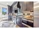 Modern kitchen features stainless steel appliances, dark cabinetry, and tile backsplash at 661 Auburn Ne Ave # 10, Atlanta, GA 30312