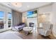 Cozy sitting room with a fireplace, comfortable seating, and access to a balcony at 661 Auburn Ne Ave # 10, Atlanta, GA 30312