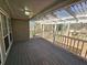 Covered back porch with a light, white railing, and wooden floor providing a perfect outdoor living space at 828 Gateshead Ct, Lawrenceville, GA 30043