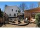 Landscaped backyard with a pergola-covered dining area and a gravel fire pit at 1637 Duncan Nw Dr, Atlanta, GA 30318