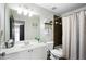 Bathroom featuring a shower/tub combo, a white vanity with a mirror, and decorative wall shelving at 1637 Duncan Nw Dr, Atlanta, GA 30318