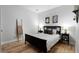 Bedroom featuring hardwood floors, white walls, and a dark bed frame with matching end tables and lamps at 1637 Duncan Nw Dr, Atlanta, GA 30318