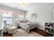 Bedroom with a metal bed frame, light pink decor, a matching chair and ottoman set, and wood floors at 1637 Duncan Nw Dr, Atlanta, GA 30318