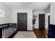 View of Bedroom featuring hardwood floors, grey walls, a dark blue crib, and a changing table at 1637 Duncan Nw Dr, Atlanta, GA 30318