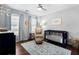 Shot of Bedroom featuring a dark blue crib, a glider, a ceiling fan, and hardwood floors at 1637 Duncan Nw Dr, Atlanta, GA 30318